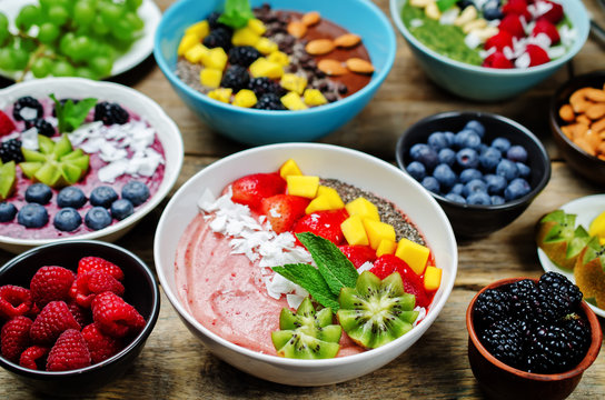 Variation with breakfast smoothie bowls with fruits and berries