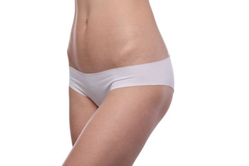 Slim woman body shape. Beautiful female wearing white underwear isolated. Healthy body, torso, slim waist, belly, abdomen close up. Sport, fitness, Dieting results.