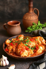 Chakhokhbili - chiken stew with garlic and cilantro (parsley) in tomato sauce.