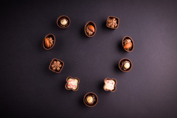 Assortment of chocolate candies on black background