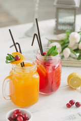 Fototapeta na wymiar Fresh drink lemonade orange strawberry cranberries