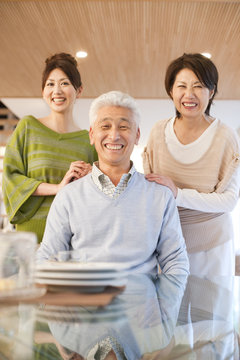 Portrait of family in dining room, smiling