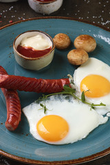 Scrambled eggs with sausages and vegetables for breakfast