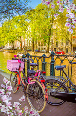 Fototapeta na wymiar Bikes on the bridge in Amsterdam, Netherlands. Canals of Amsterdam.