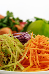 Vegetables sliced on a grater for salad. Still life in high key. Place for the text. Isolated