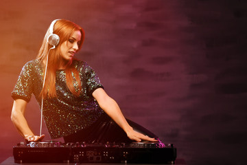 Fototapeta na wymiar DJ mixing music on color background