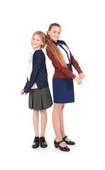 Fototapeta premium Two cute girls in school uniform on white background