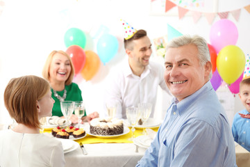 Family celebrating birthday at home