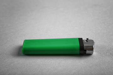 Blank green cigarette lighter on grey background