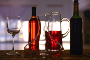 Decanter and glass on table against blurred background