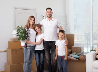 Fototapeta na wymiar House move concept. Happy family standing in new home
