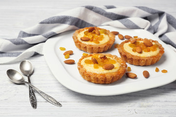 Plate with delicious crispy tarts on wooden background