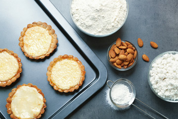 Baking tray with delicious crispy tarts on table