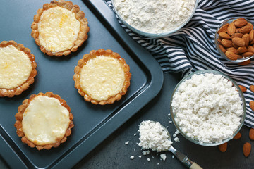 Baking tray with delicious crispy tarts on table