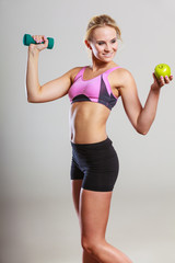 Diet fit body. Girl holds dumbbells and apple fruit