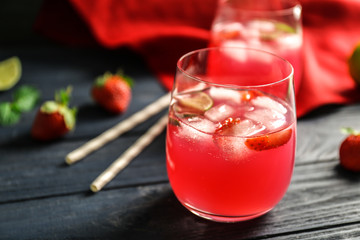 Refreshing cocktails with strawberry on wooden table