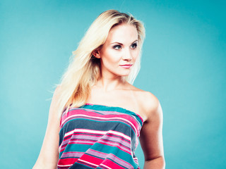Blonde woman wearing colorful striped strapless shirt