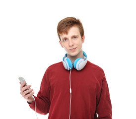 Teenager with headphones and mobile phone on white background