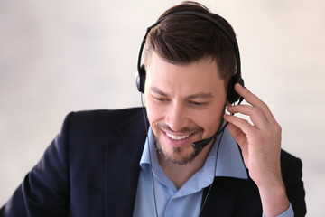 Young man with headset working in office © Africa Studio