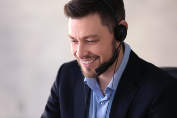 Young man with headset working in office