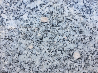 Macro closeup of granite stone rock abstract surface grained background
