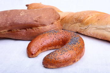 Assorted fresh breads isolated on old sackcloth.