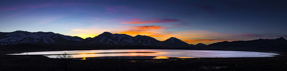 Desert lake, flooded playa at Sunset with mountain ranges and colorful clouds.  White Lake,  Cold Springs, Nevada