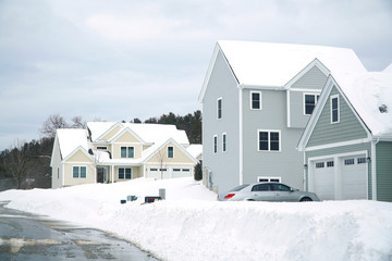 houses in residential community after snow in winter