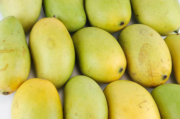 close up on fresh mangoes background