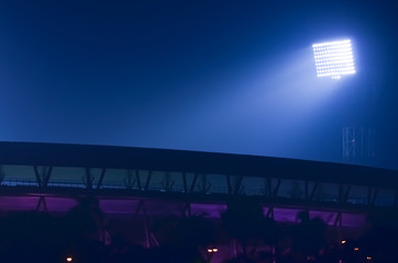 It situated at Kolkata, India. Stadium floodlights against a dark night sky background.