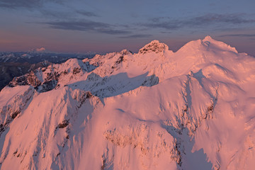 Fototapeta na wymiar Three Fingers Mountain Red Lighting Aerial Photo North Cascades Mountains Winter View