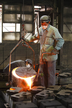 Two men working in foundry