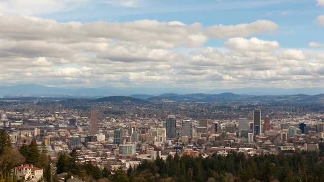 Time lapse of freeway traffic and moving white clouds over urban cityscape of downtown Portland Oregon one winter day 4k uhd 4096x2304