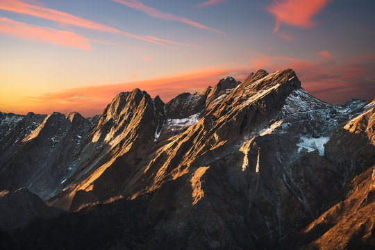 Fototapeta Alpi Apuane snowy mountains and marble quarry at sunset in winter. Carrara, Tuscany, Italy.