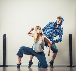 couple of young man and woman dancing hip-hop