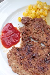 Grilled pork steak with  bread and ketchup.