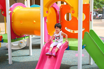 asian baby child girl playing on playground, slider