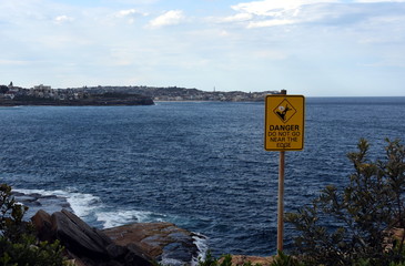 Sydney, Australia - Feb 5, 2017. Sign at the cliff's edge shows 