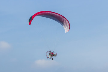 man active extreme sports pilot flying in the sky with paramotor paraglider paraglider motor.
