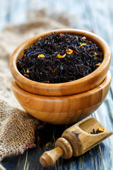 Bowls of black tea with bergamot and scoop.