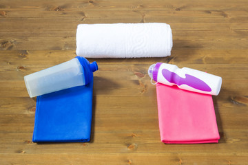 Two towels and bottles for sports for men and women