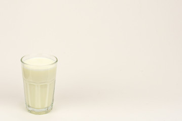 A glass of milk over white background
