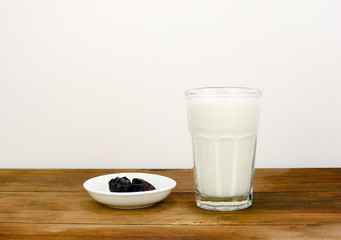 Dates and milk for Ramadhan breaking fast on wooden surface
