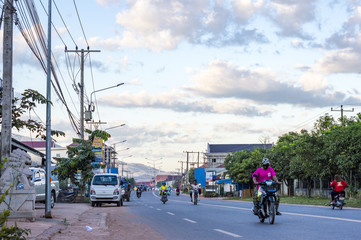 People ride motorcycles on the street in Laos