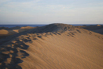 Sand dunes of the Maspalomas desert near the Atlantic Ocean, Gran Canaria, Spain.
