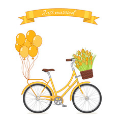 Yellow retro bicycle with tulip bouquet in floral basket and balloons attached to the trunk