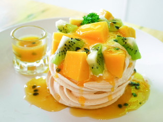 delicious tropical pavlova with kiwi and mango