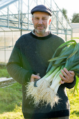 Portrait of Farmer with Bundle of Leeks and Pruning Knife
