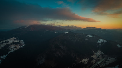 flying in the mountains at sunset. aerial photography