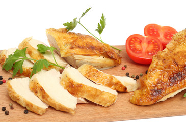 Grilled chicken fillet with tomato on wood background